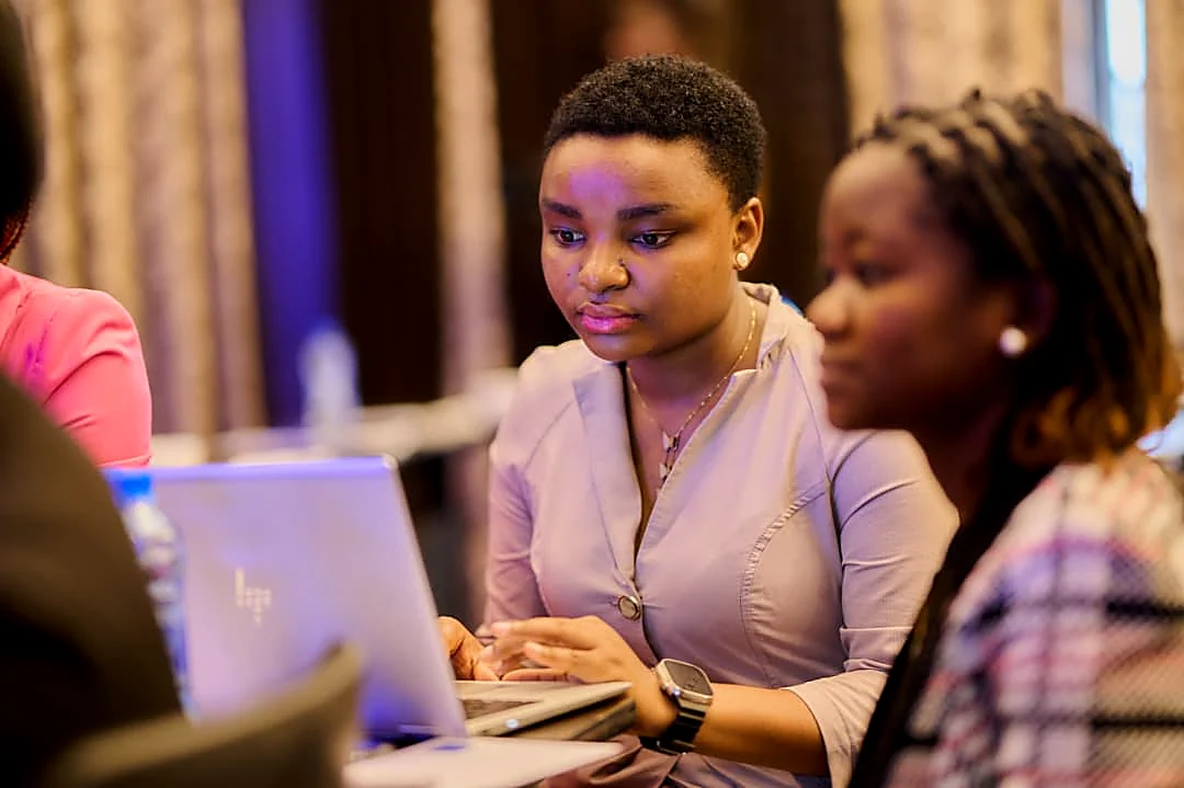 A young woman working on a laptop during a training session